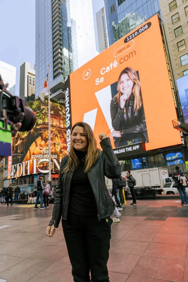 Andreza Araújo en Times Square frente a una pantalla de campaña